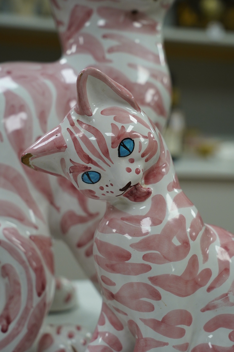 A large 1950's Italian pink maiolica seated cat and two smaller, largest 45cm. Condition - poor